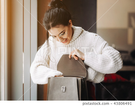 Fashionable woman hold black bag 43806491