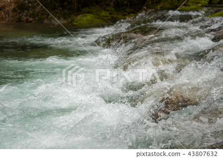 A river of clear water flows fast 43807632