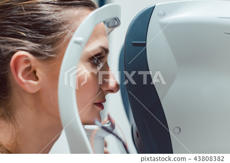 Woman having eyesight test using modern refractometer Woman having eyesight test using modern refractometer 43808382