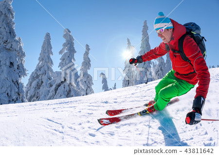 Skier skiing downhill in high mountains Skier skiing downhill in high mountains 43811642