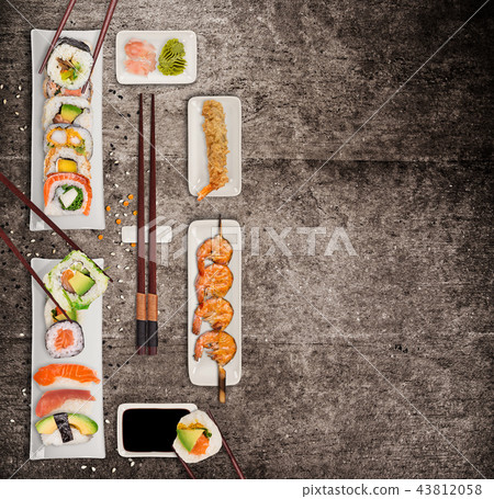 Traditional japanese sushi pieces on rustic concrete background. Traditional japanese sushi pieces on rustic concrete background. 43812058