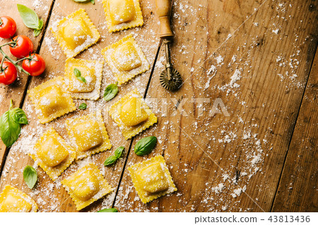 Cooking italian ravioli on wooden table Cooking italian ravioli on wooden table 43813436