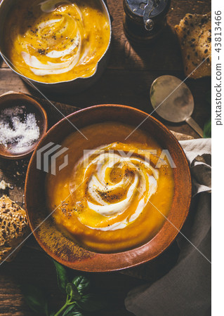 Autumn pumpkin creamy soup in bowls Autumn pumpkin creamy soup in bowls 43813466