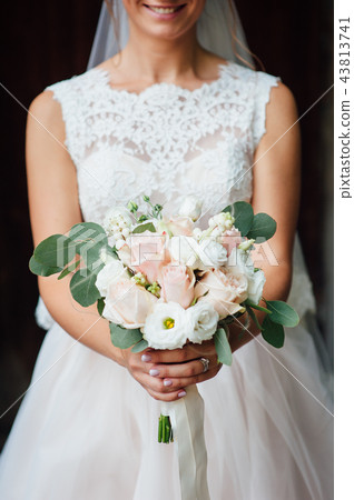 closeup of bride hands holding beautiful wedding bouquet closeup of bride hands holding beautiful wedding bouquet 43813741