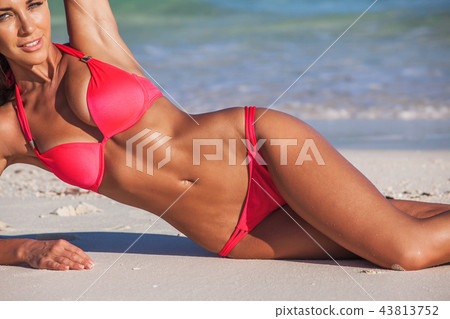 Woman laying by sea 43813752
