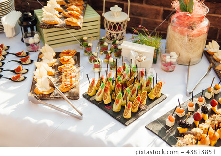 Delicious snacks on wedding reception table in... - Stock Photo [43813851]  - PIXTA