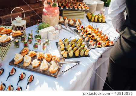 Delicious snacks on wedding reception table in... - Stock Photo [43813855]  - PIXTA