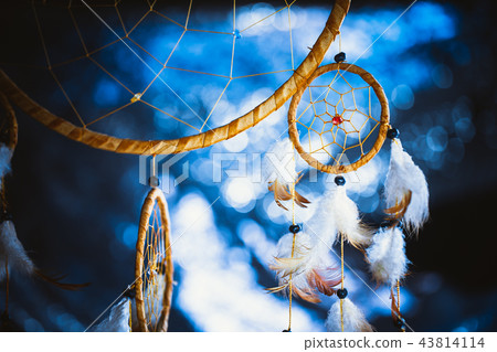 Dreamcatcher against a white blur of snow 43814114