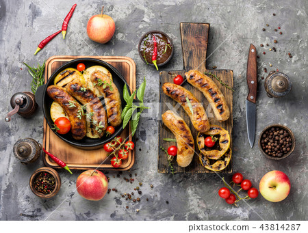 Grilled sausages on cutting board 43814287