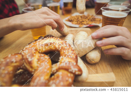Boiled white sausages, served with beer and pretzels. Perfect for Octoberfest. Natural wooden 43815011
