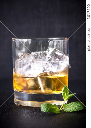 Glass of rum on the dark background 43817200