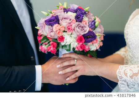 Weddin bouquet in newlyweds hands Weddin bouquet in newlyweds hands 43817846
