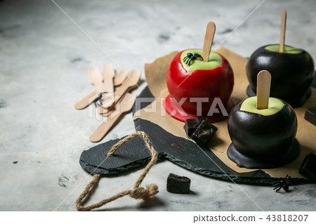 Halloween style sweets - black poisoned, red and orange caramel apples Halloween style sweets - black poisoned, red and orange caramel apples 43818207