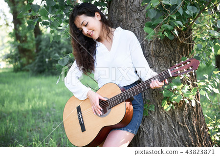 young woman is in the forest with guitar 43823871