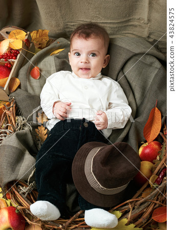 autumn concept - child boy lie on yellow leaves 43824575