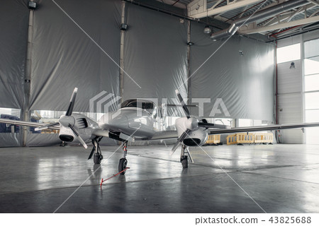 Private turbo-propeller airplane in hangar, nobody Private turbo-propeller airplane in hangar, nobody 43825688
