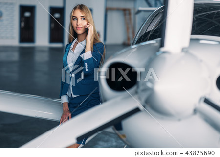 Stewardess against propeller engine of airplane Stewardess against propeller engine of airplane 43825690