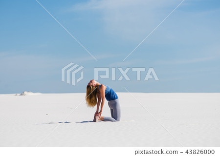 Ustrasana camel yoga pose in the desert 43826000
