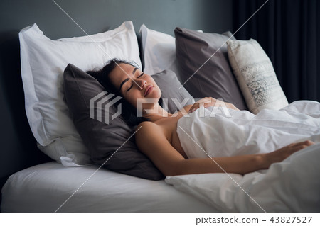 hotel, travel and happiness concept - beautiful woman sleeping in bed hotel, travel and happiness concept - beautiful woman sleeping in bed 43827527