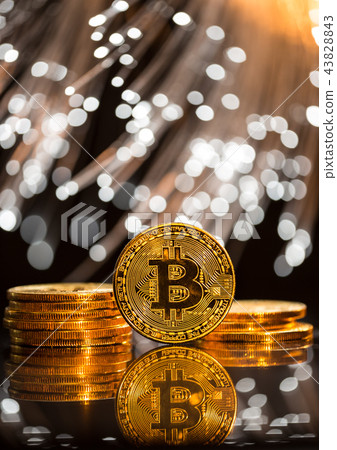 Bitcoin gold coins with defocused abstract background. Virtual cryptocurrency concept. Bitcoin gold coins with defocused abstract background. Virtual cryptocurrency concept. 43828843