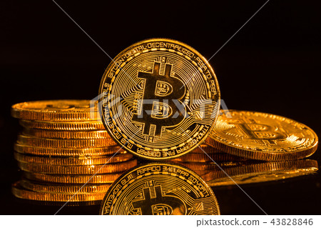 Bitcoin gold coins with defocused abstract background. Virtual cryptocurrency concept. Bitcoin gold coins with defocused abstract background. Virtual cryptocurrency concept. 43828846