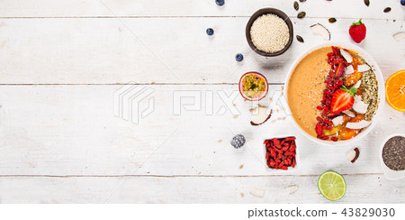 Smoothie bowl with fresh berries, nuts, seeds, fruit and vegetables. Smoothie bowl with fresh berries, nuts, seeds, fruit and vegetables. 43829030