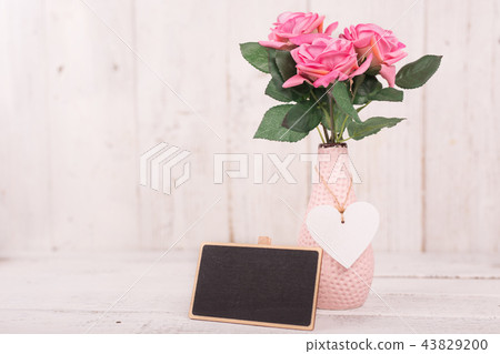 Flowers composition for Valentine's, Mother's or Women's Day. Pink flowers on old white wooden background. 43829200