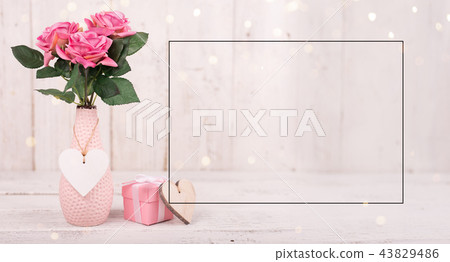 Flowers composition for Valentine's, Mother's or Women's Day. Pink flowers on old white wooden background. 43829486