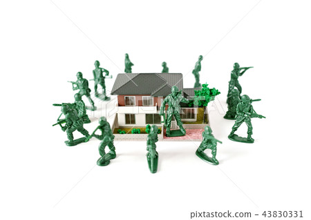 Miniature soldier protecting a house Miniature soldier protecting a house 43830331