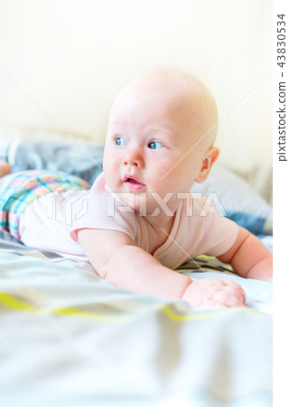 Cheerful baby boy in morning bedroom Child relaxing Cheerful baby boy in morning bedroom Child relaxing 43830534
