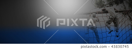 Military soldier climbing a net during obstacle course 43830745