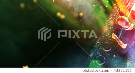 Dj mixes the track in the nightclub at a party Dj mixes the track in the nightclub at a party 43831195