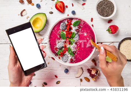 Smoothie bowl with fresh berries, nuts, seeds, fruit and vegetables. Smoothie bowl with fresh berries, nuts, seeds, fruit and vegetables. 43831196