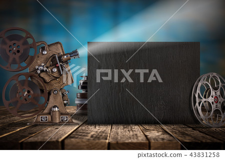 Cinema concept of vintage film reels, black board and projector. Cinema concept of vintage film reels, black board and projector. 43831258