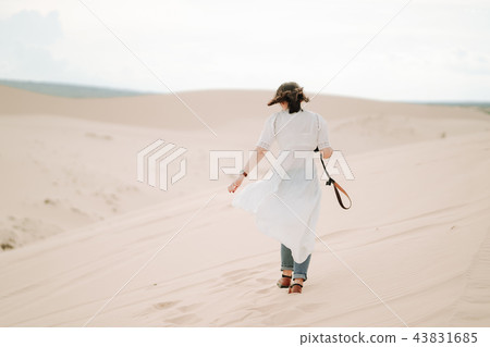 Female exploring the desert, sandy beach camera. Female exploring the desert, sandy beach camera. 43831685
