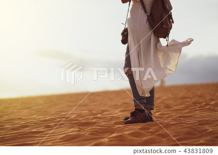 Woman exploring the desert, sandy beach with bag. Woman exploring the desert, sandy beach with bag. 43831809
