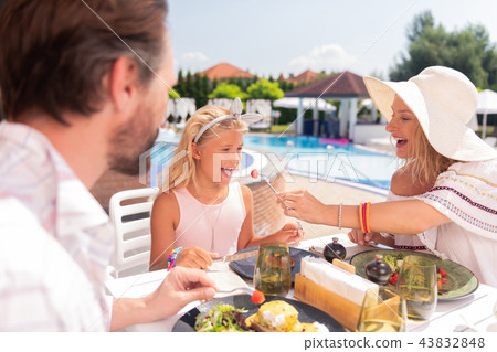 Delighted happy girl looking at the tomato Delighted happy girl looking at the tomato 43832848