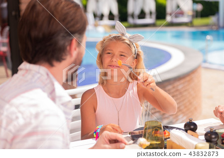 Joyful positive girl offering her dad to try 43832873