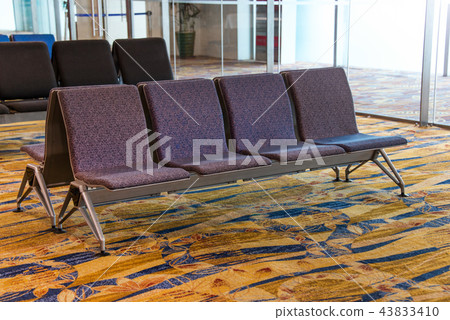 A row of chair at the lobby of airport 43833410