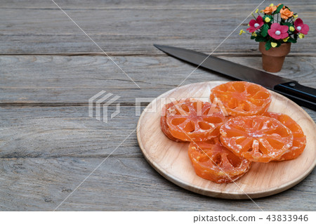 boiled bael fruits in syrup on wooden table 43833946