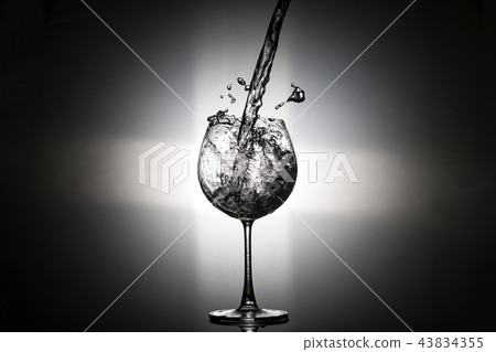 Pouring water in to the wine glass  43834355