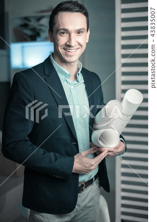 Young nice intern holding plan of house Young nice intern holding plan of house 43835007