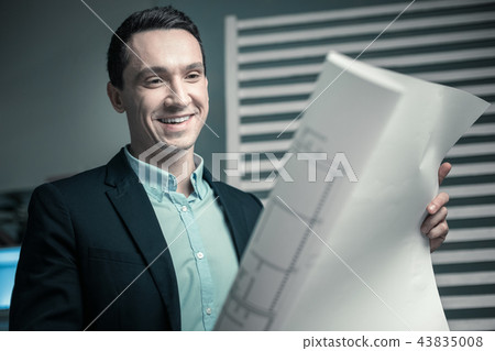 Cheerful leader approving professional drawings of his employee Cheerful leader approving professional drawings of his employee 43835008