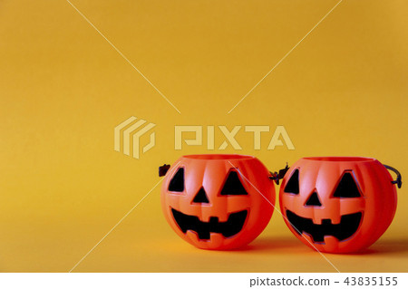 pumpkins bucket on yellow background  43835155