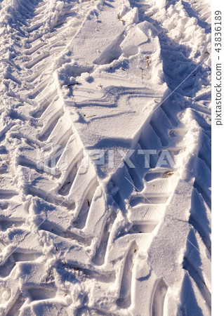 Traces of the car on the snow 43836189