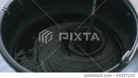 closeup mixing dark gray micro concrete plaster 43837228