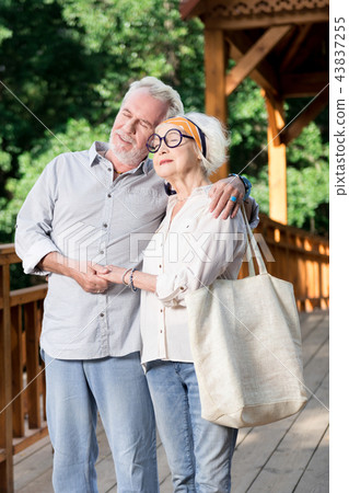 Aged people hugging and feeling good while standing together Aged people hugging and feeling good while standing together 43837255