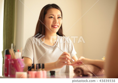 A woman who is nailing A woman who is nailing 43839338