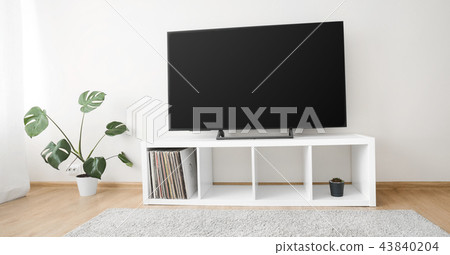 Cozy home interior with TV and monstera palm 43840204