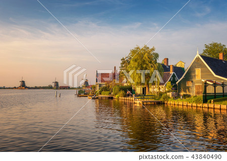 Sunset above farm houses and windmills of Zaanse Schans in Holland 43840490